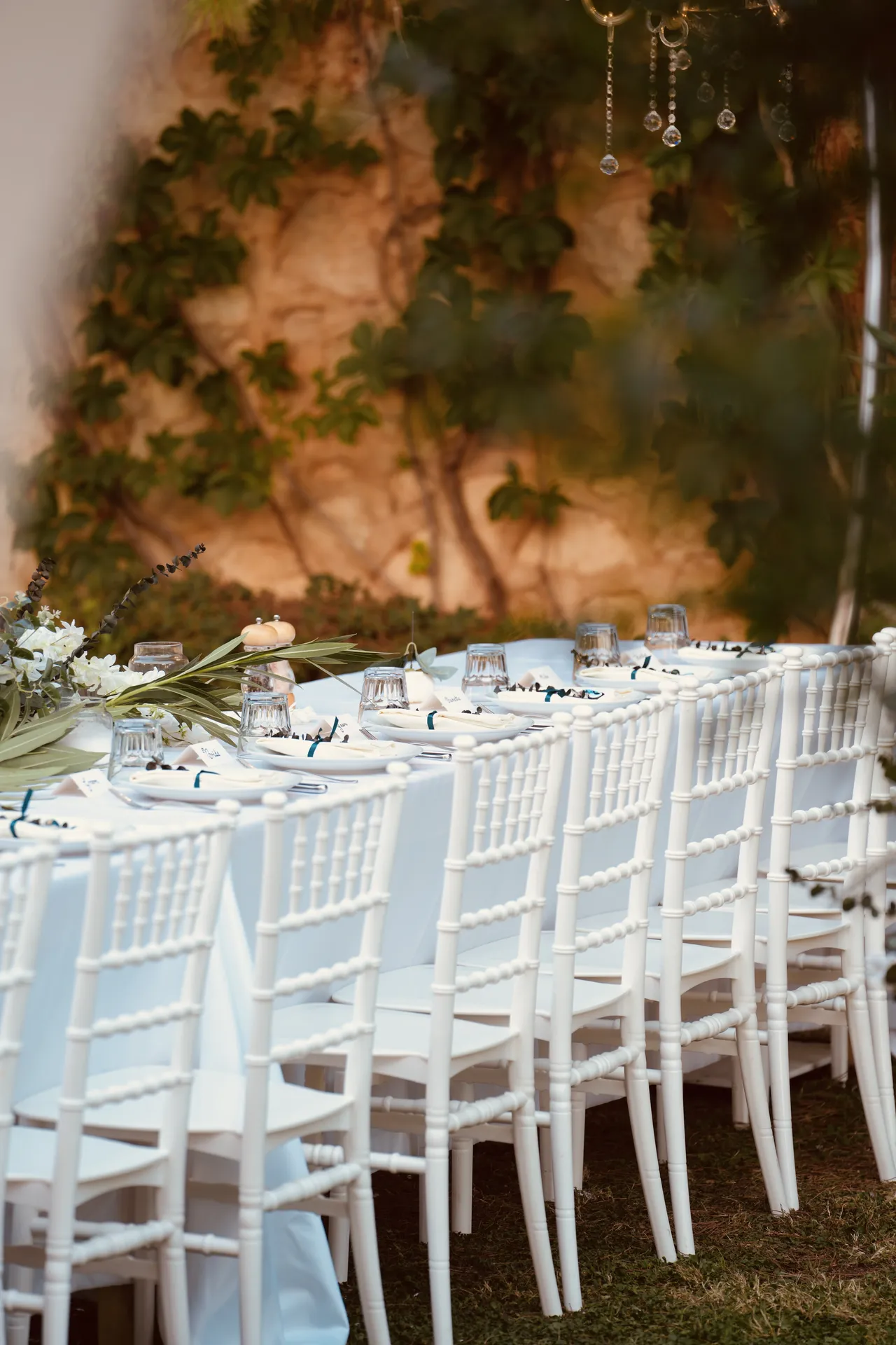 Long reception table setup with elegant place settings