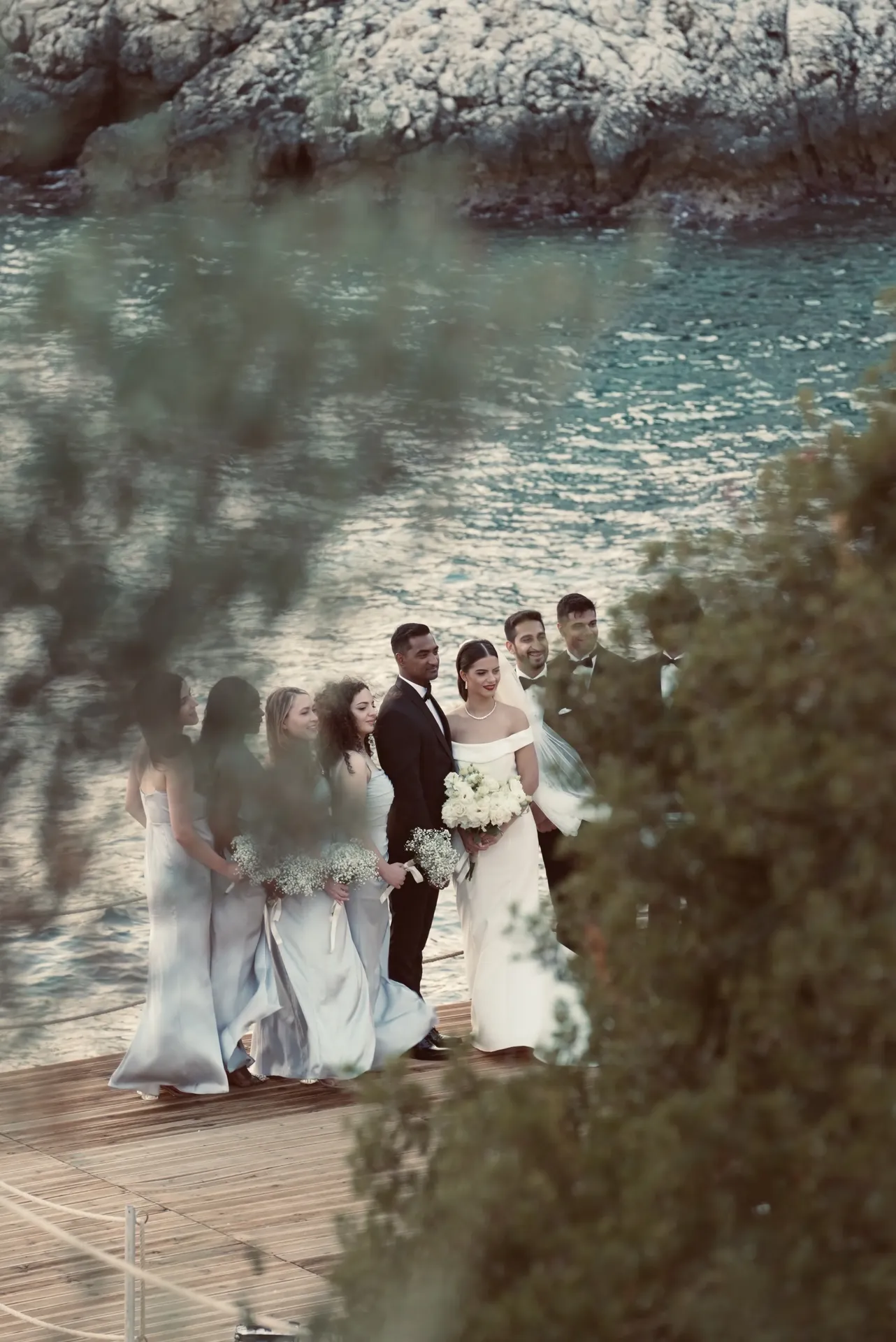 Full wedding party on deck with Mediterranean sea backdrop